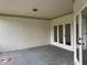 Spacious, covered outdoor patio featuring neutral colors, overhead light, and views of the backyard at 2450 Sweetwater Country Club Dr, Apopka, FL 32712