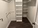 Spacious walk-in closet featuring a built-in shelving unit for organization and storage at 2450 Sweetwater Country Club Dr, Apopka, FL 32712