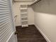 Bright walk-in closet with custom shelving and hanging rods provides ample storage space at 2450 Sweetwater Country Club Dr, Apopka, FL 32712