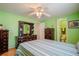 Green bedroom includes ceiling fan, two dressers, and access to an ensuite bathroom at 2475 Karen Dr, Mount Dora, FL 32757