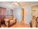 Bright bedroom includes a chair, wood floors, and access to an ensuite bathroom at 2475 Karen Dr, Mount Dora, FL 32757