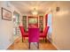 Elegant dining area with chandelier, wooden floors, and a view into the kitchen at 2475 Karen Dr, Mount Dora, FL 32757