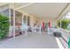 Inviting covered porch with charming decorations, including a picket fence, seating, and views of the street at 2475 Karen Dr, Mount Dora, FL 32757