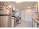 Functional kitchen with stainless steel appliances, tile floors, and ample cabinet space and pantry at 2475 Karen Dr, Mount Dora, FL 32757