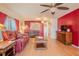 Cozy living room featuring wood floors, ceiling fans, and comfortable seating at 2475 Karen Dr, Mount Dora, FL 32757