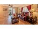 Comfortable living room with hardwood floors and cozy furniture, with access to the screened in porch at 2475 Karen Dr, Mount Dora, FL 32757