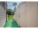 Exterior shot of backyard shed with double doors, showcasing additional storage space on a grassy area at 2475 Karen Dr, Mount Dora, FL 32757