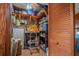 Cluttered storage room featuring a wooden door, shelves and various household items at 2475 Karen Dr, Mount Dora, FL 32757