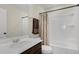 Bathroom featuring a white vanity, shower/tub combo and decorative towel racks at 2532 Autumn Stream Dr, Leesburg, FL 34748