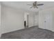 Spacious bedroom with a ceiling fan, neutral walls, and plush carpet at 2532 Autumn Stream Dr, Leesburg, FL 34748