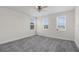 Bright bedroom with ceiling fan and three large windows providing natural light at 2532 Autumn Stream Dr, Leesburg, FL 34748