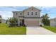 Charming two-story home featuring a spacious two-car garage and a well-maintained lawn at 2532 Autumn Stream Dr, Leesburg, FL 34748