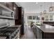 Modern kitchen featuring stainless steel appliances and a spacious island with barstool seating at 2532 Autumn Stream Dr, Leesburg, FL 34748