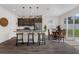 Bright and open kitchen with dark wood cabinets, stainless appliances, and an island with bar seating at 2532 Autumn Stream Dr, Leesburg, FL 34748