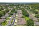 A high-angle view showcases a well-maintained residential area, with mature trees and manicured lawns at 264 Juniper Way, Tavares, FL 32778