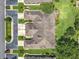 An aerial view showcases the home's roof, driveway, and surrounding landscaped greenery at 264 Juniper Way, Tavares, FL 32778