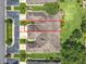 An aerial view showcases the home's roof, driveway, and surrounding landscaped greenery at 264 Juniper Way, Tavares, FL 32778