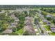 A high-angle view showcases a well-maintained residential area, with mature trees and manicured lawns at 264 Juniper Way, Tavares, FL 32778
