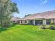 Lush green backyard featuring well-maintained lawn, perfect for outdoor relaxation and entertaining at 264 Juniper Way, Tavares, FL 32778