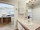 Bathroom featuring a sink and vanity, with an open view into the kitchen area at 264 Juniper Way, Tavares, FL 32778