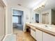 Bright bathroom featuring a vanity with ample counter space and access to the bedroom at 264 Juniper Way, Tavares, FL 32778