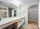 Bright bathroom with updated sink, long vanity, walk-in closet, and shower at 264 Juniper Way, Tavares, FL 32778