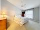 Bedroom with light walls, a ceiling fan, a large window and carpeted flooring at 264 Juniper Way, Tavares, FL 32778