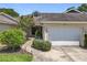 Charming townhome with attached garage, tidy landscaping, and a welcoming facade at 264 Juniper Way, Tavares, FL 32778