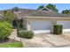 Charming townhome with attached garage, tidy landscaping, and a welcoming facade at 264 Juniper Way, Tavares, FL 32778