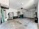 Spacious garage with storage shelving and a roll-up door at 264 Juniper Way, Tavares, FL 32778