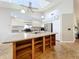 Open kitchen with center island and stainless appliances provides lots of storage at 264 Juniper Way, Tavares, FL 32778