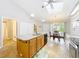 Open kitchen features a center island, dining area, and plenty of natural light at 264 Juniper Way, Tavares, FL 32778