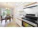 Bright eat-in kitchen features stainless steel appliances and neutral countertops at 264 Juniper Way, Tavares, FL 32778