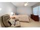 Comfortable main bedroom offers a relaxing retreat with neutral walls and carpeted floors at 264 Juniper Way, Tavares, FL 32778