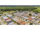 Aerial view of community featuring homes, green lawns and mature trees, blending for community aesthetic at 2805 Burgos Dr, The Villages, FL 32162