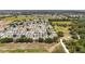 Scenic aerial view of a well-maintained neighborhood, bordered by expansive fields and mature trees at 2805 Burgos Dr, The Villages, FL 32162