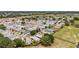 An aerial view captures a vibrant residential community, complemented by verdant lawns and mature trees at 2805 Burgos Dr, The Villages, FL 32162