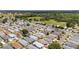 Expansive aerial view of a meticulously planned residential community, bordered by lush greenery and open fields at 2805 Burgos Dr, The Villages, FL 32162