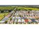An expansive aerial view highlights the community, surrounded by lush greenery and open fields for recreation at 2805 Burgos Dr, The Villages, FL 32162