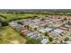 An aerial perspective presents a residential community with neatly lined homes, green spaces, and mature trees at 2805 Burgos Dr, The Villages, FL 32162