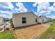 A view of the backyard, showing the low maintenance landscaping and modern AC unit at 2805 Burgos Dr, The Villages, FL 32162