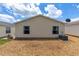 View of the backyard with a modern AC unit, complemented by low-maintenance gravel landscaping at 2805 Burgos Dr, The Villages, FL 32162