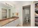 Bathroom featuring stone countertops, a large mirror, and a neutral color scheme at 2805 Burgos Dr, The Villages, FL 32162