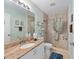 Tiled bathroom with walk-in shower, vanity, and tasteful decor at 2805 Burgos Dr, The Villages, FL 32162