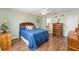 Charming bedroom with hardwood floors, ceiling fan, and comfortable furnishings at 2805 Burgos Dr, The Villages, FL 32162