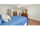 Bright bedroom featuring a ceiling fan, wooden floors, and an ensuite bathroom at 2805 Burgos Dr, The Villages, FL 32162