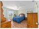 Comfortable bedroom featuring wood flooring and bright window with dresser at 2805 Burgos Dr, The Villages, FL 32162