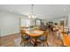 Charming dining area featuring a wood table, chairs, and a decorative centerpiece at 2805 Burgos Dr, The Villages, FL 32162