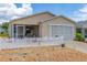 Charming single-story home featuring a screened-in porch and a white picket fence at 2805 Burgos Dr, The Villages, FL 32162