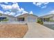 Inviting single-story home with a well-maintained lawn and a covered screened entrance at 2805 Burgos Dr, The Villages, FL 32162